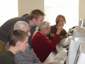 Student volunteers teaching senior citizens 