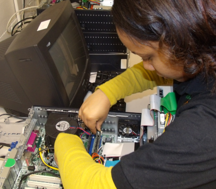 A Student Volunteer Troubleshooting and Repairing Computers